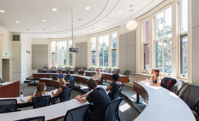 A classroom with seats and tables in a semi-circle
