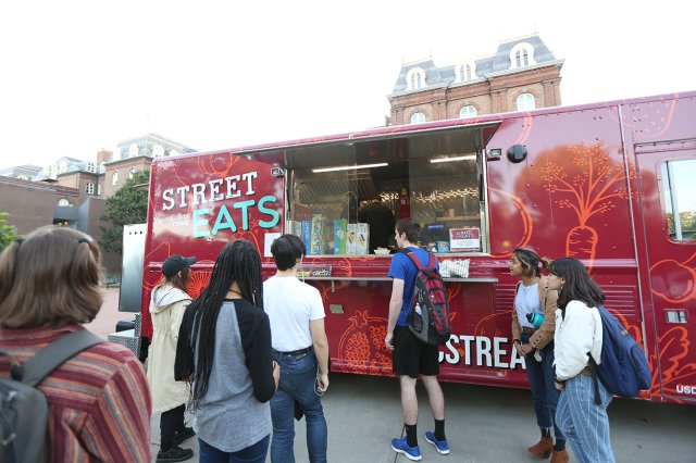 Students waiting in line at a food truck