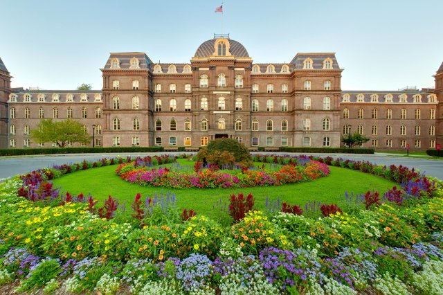 Exterior photo of Main Building with a colorful garden in the foreground