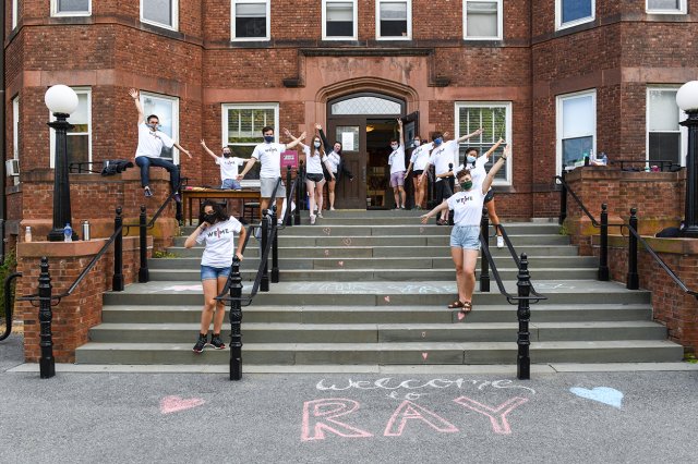 Students on the exterior steps to a Residential House