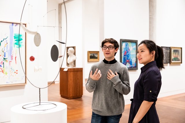 Students admiring a sculpture
