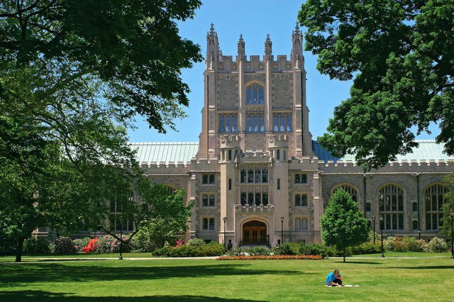 A large Gothic building flanked by trees
