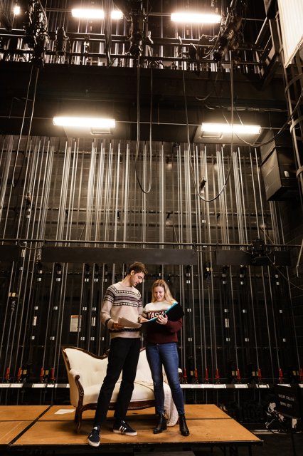 Two students standing on a stage