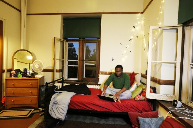 A student sitting in a dorm room